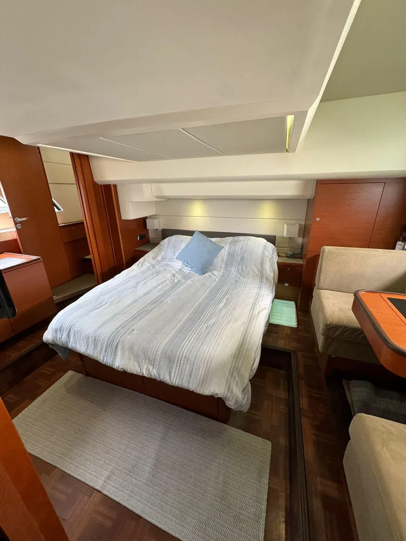 Slide: The Image of Luxurious bedroom interior of 2014 Prestige 550 Fly yacht with cozy bed and elegant decor. - 29
