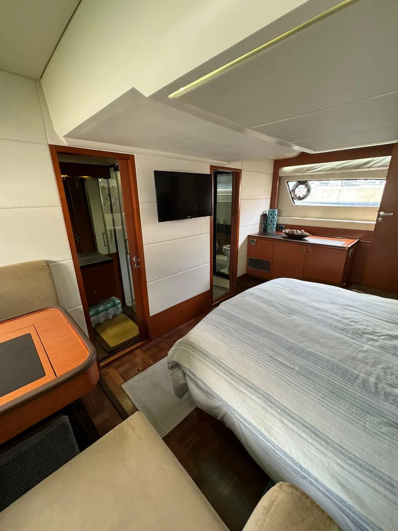 Slide: The Image of Interior of 2014 Prestige 550 Fly yacht with bed, TV, and window view. - 30