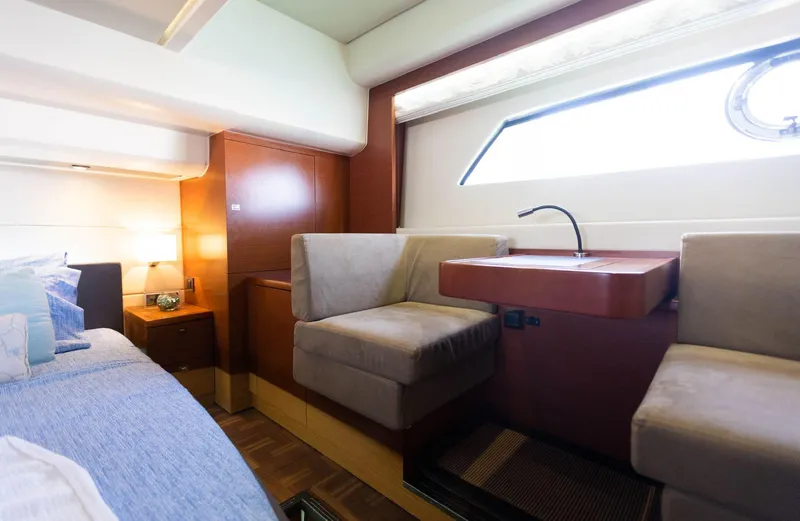 Slide: The Image of Luxurious interior of a 2014 Prestige 550 Fly yacht cabin with modern furnishings. - 35