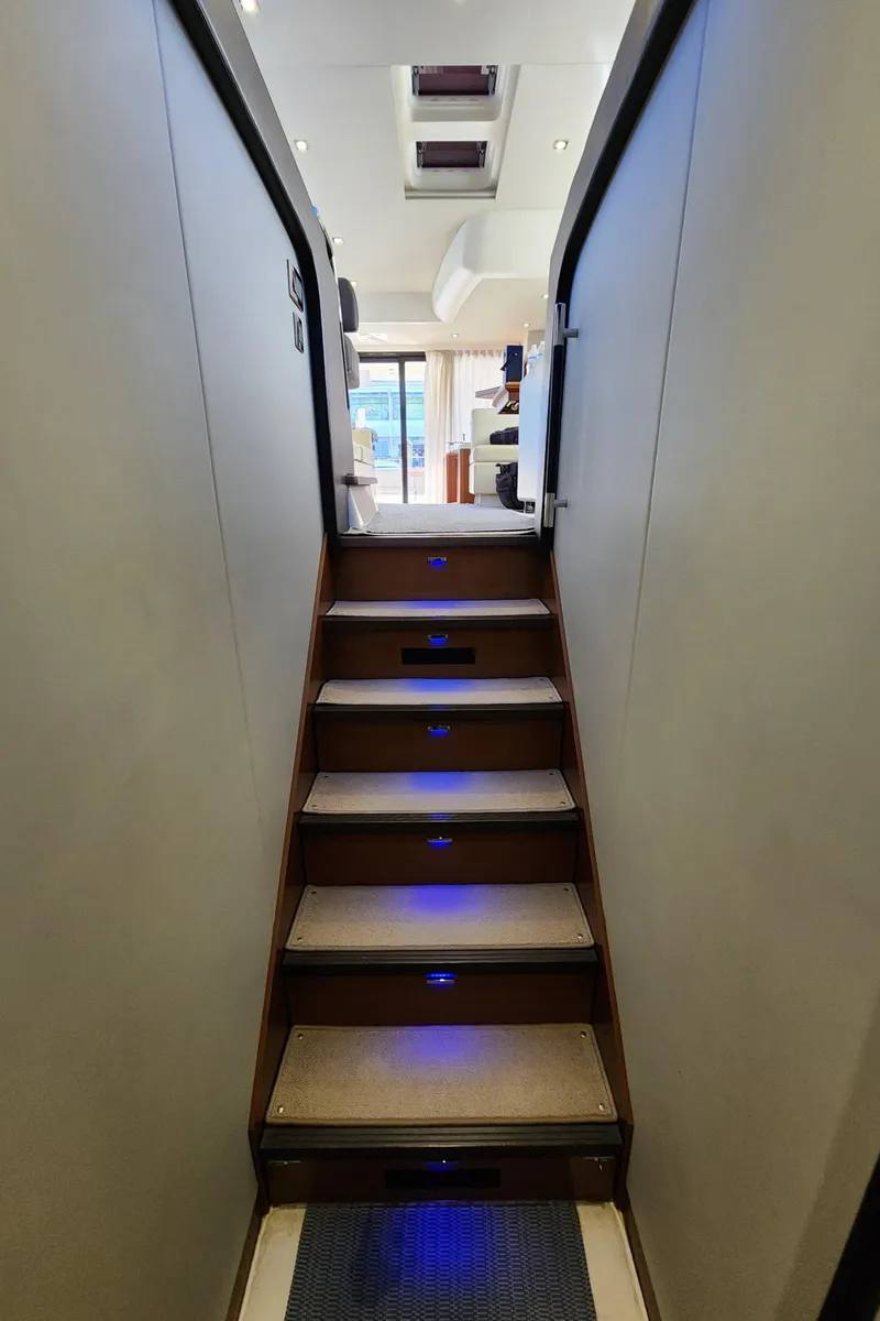 Slide: The Image of Staircase with blue LED lights inside 2014 Prestige 550 Fly yacht. - 41