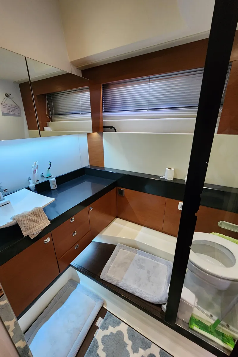 Slide: The Image of Luxurious bathroom in a 2014 Prestige 550 Fly yacht with modern fixtures and elegant design. - 46