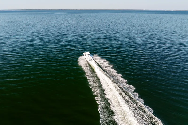 Slide: The Image of 2023 Twin Vee 260 GFX CC boat on open sea. - 10