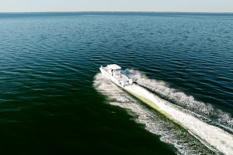 Slide: The Image of 2023 Twin Vee 260 GFX CC boat on open sea. - 11