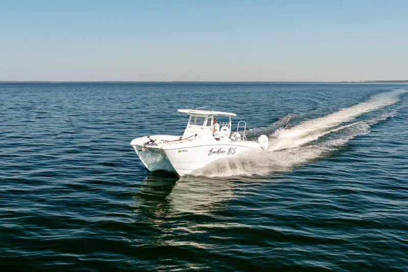 Slide: The Image of 2023 Twin Vee 260 GFX CC boat cruising on open sea. - 15