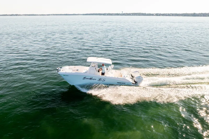 Slide: The Image of 2023 Twin Vee 260 GFX CC boat cruising on calm waters. - 22