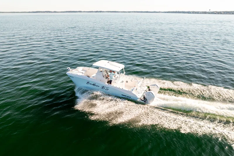 Slide: The Image of 2023 Twin Vee 260 GFX CC boat cruising on calm waters. - 23