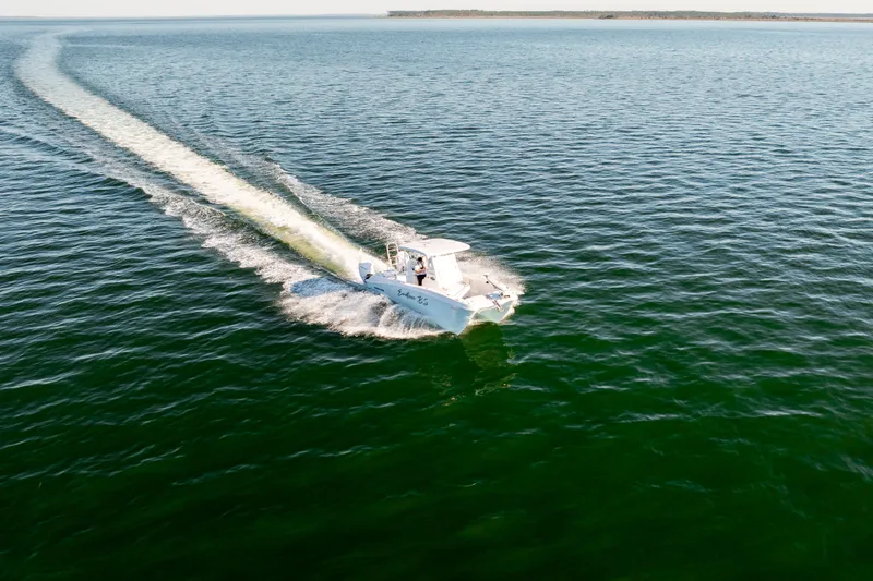 Slide: The Image of 2023 Twin Vee 260 GFX CC boat cruising on open water. - 28