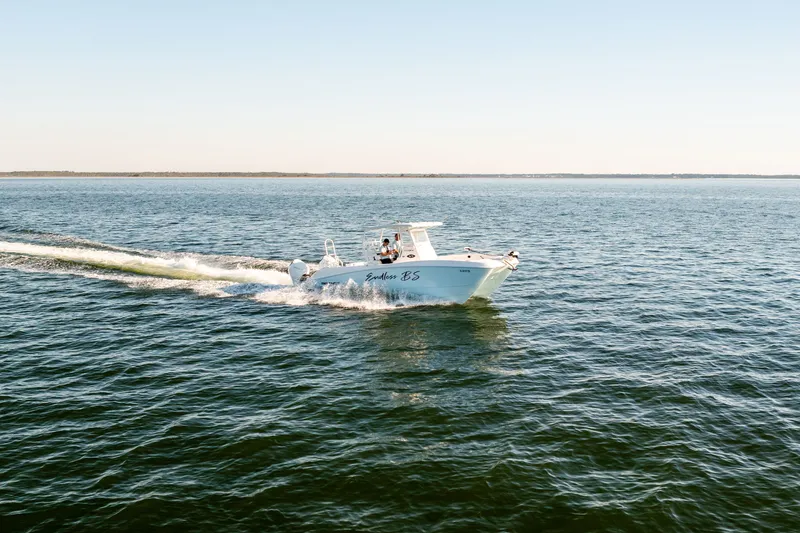 Slide: The Image of 2023 Twin Vee 260 GFX CC boat cruising on open sea. - 29