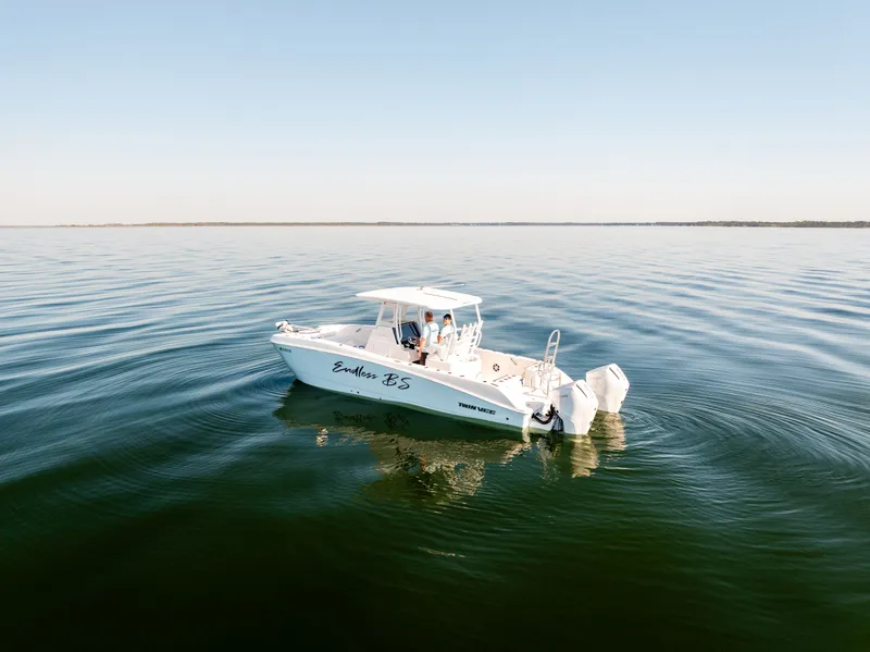 Slide: The Image of 2023 Twin Vee 260 GFX CC boat on calm water. - 3