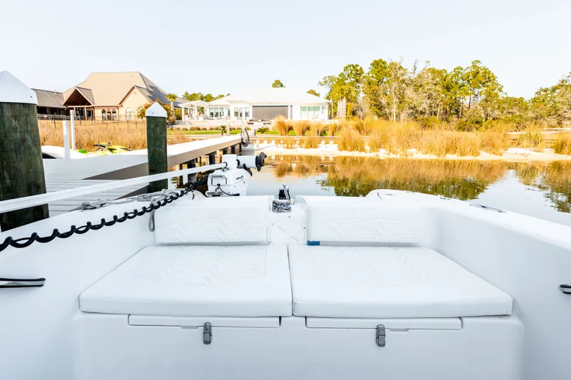 Slide: The Image of 2023 Twin Vee 260 GFX CC boat at serene lakeside. - 36