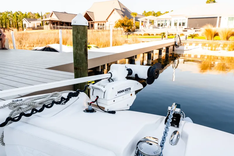 Slide: The Image of 2023 Twin Vee 260 GFX CC boat at dock with Minn Kota motor. - 37