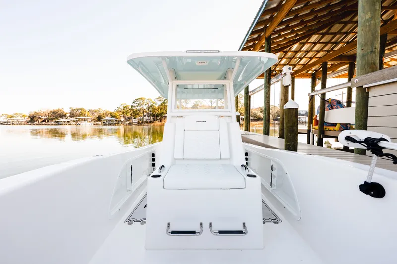 Slide: The Image of 2023 Twin Vee 260 GFX CC boat at serene lakeside. - 38