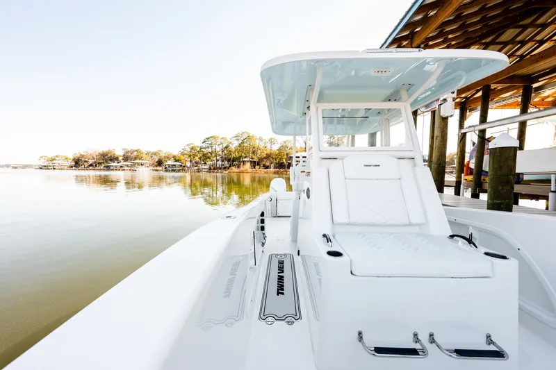 Slide: The Image of 2023 Twin Vee 260 GFX CC boat at serene lakeside. - 39