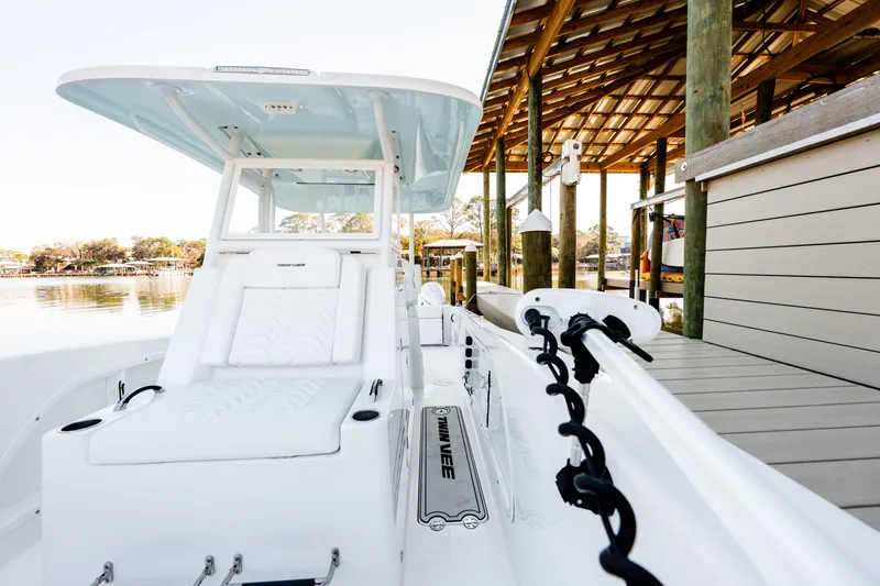 Slide: The Image of 2023 Twin Vee 260 GFX CC boat at dock, modern design. - 40