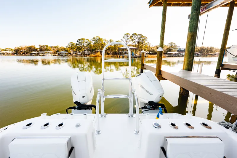 Slide: The Image of 2023 Twin Vee 260 GFX CC boat at serene lakeside. - 48