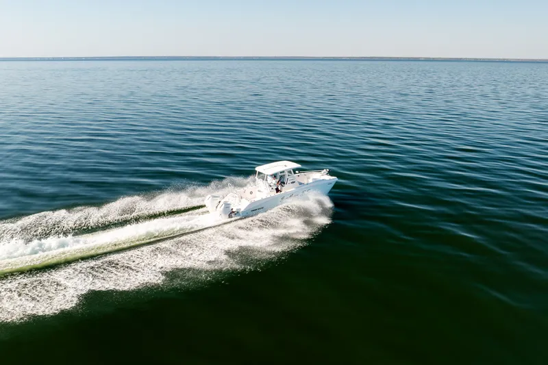 Slide: The Image of 2023 Twin Vee 260 GFX CC cruising on calm waters. - 7