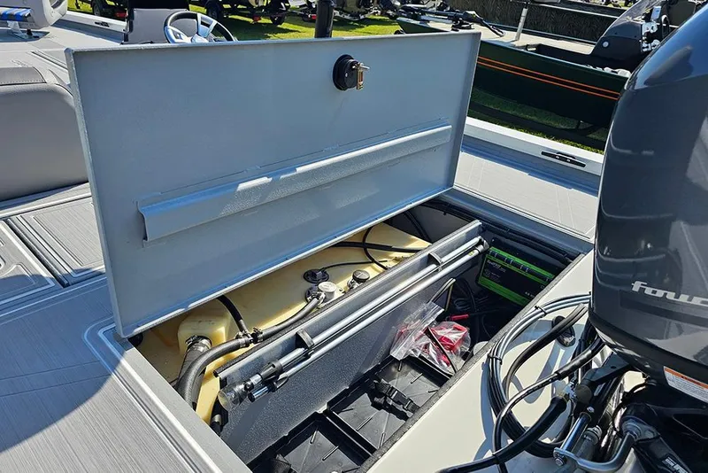 Slide: The Image of Open storage compartment on 2026 G3 Sportsman 1810 SE boat, revealing internal components. - 10