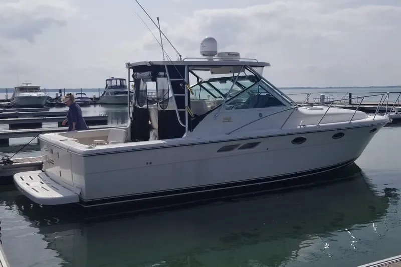 The Image of 2003 Tiara Yachts 3100 Open LE docked at marina with person on deck. - 0