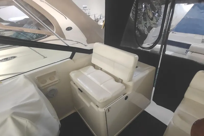 Slide: The Image of 2003 Tiara Yachts 3100 Open LE interior with white seating and helm area. - 10