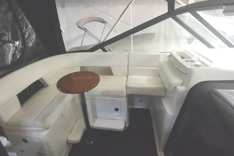 Slide: The Image of Interior of 2003 Tiara Yachts 3100 Open LE with white seating and small wooden table. - 11