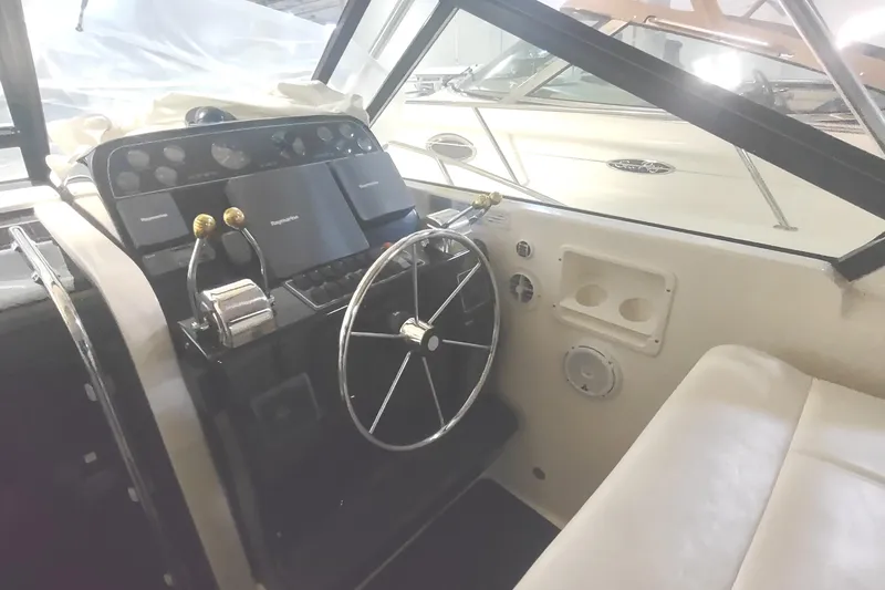 Slide: The Image of 2003 Tiara Yachts 3100 Open LE helm with steering wheel and control panel. - 12