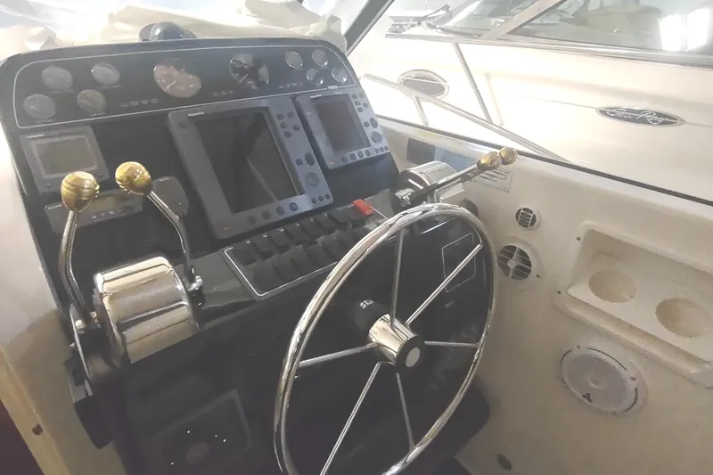 Slide: The Image of 2003 Tiara Yachts 3100 Open LE helm with steering wheel and control panel. - 13