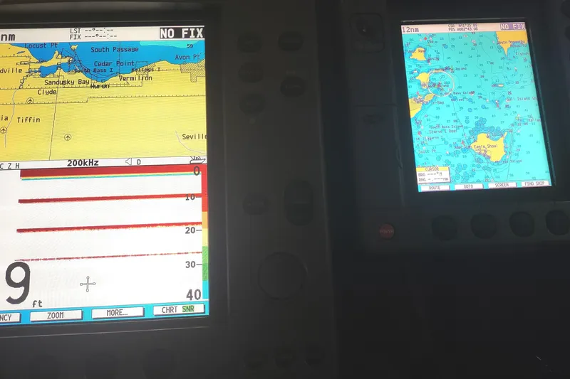 Slide: The Image of Navigation screens on a 2003 Tiara Yachts 3100 Open LE, displaying nautical charts and sonar data. - 16
