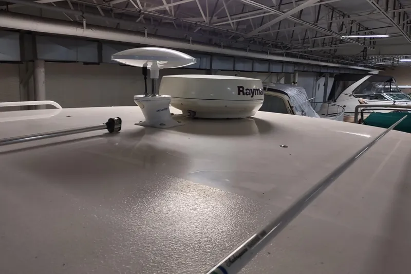 Slide: The Image of 2003 Tiara Yachts 3100 Open LE radar equipment on deck in a marina setting. - 19