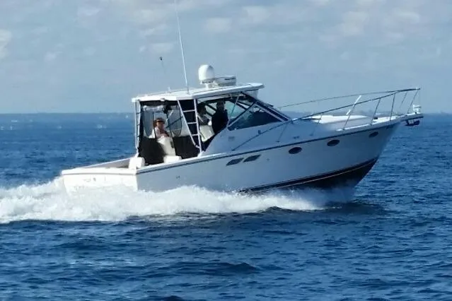 Slide: The Image of 2003 Tiara Yachts 3100 Open LE cruising on open water. - 2