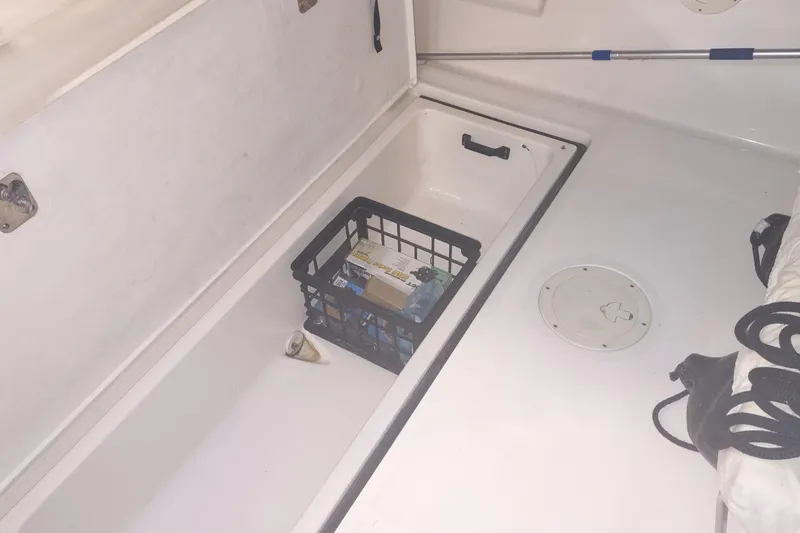 Slide: The Image of Storage compartment on a 2003 Tiara Yachts 3100 Open LE with crate and items. - 25