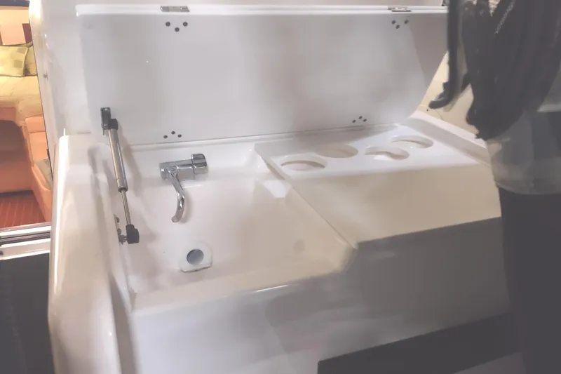 Slide: The Image of 2003 Tiara Yachts 3100 Open LE interior sink and cup holder detail. - 27