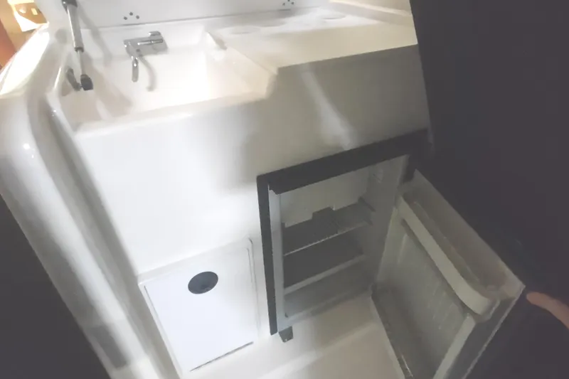 Slide: The Image of 2003 Tiara Yachts 3100 Open LE interior with sink and open refrigerator. - 28