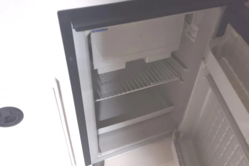 Slide: The Image of Open refrigerator inside a 2003 Tiara Yachts 3100 Open LE boat. - 29