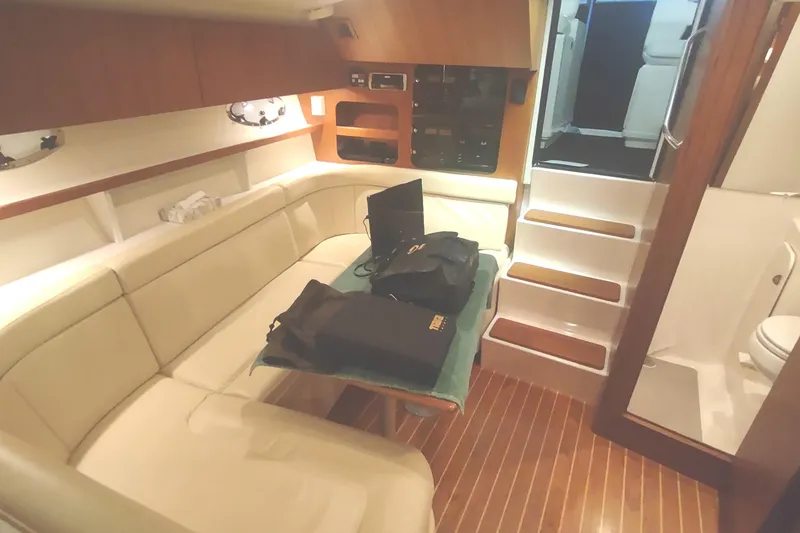Slide: The Image of Interior of 2003 Tiara Yachts 3100 Open LE with beige seating and wooden flooring. - 31