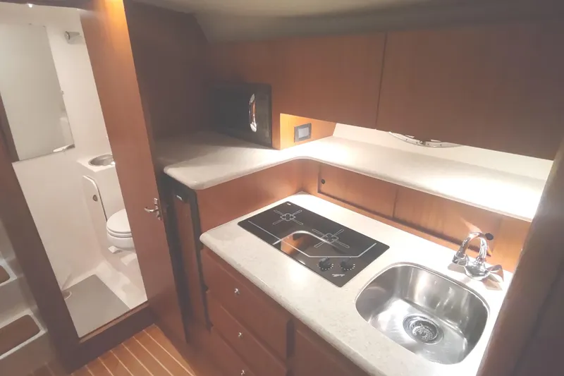 Slide: The Image of 2003 Tiara Yachts 3100 Open LE interior with kitchenette and bathroom. - 32