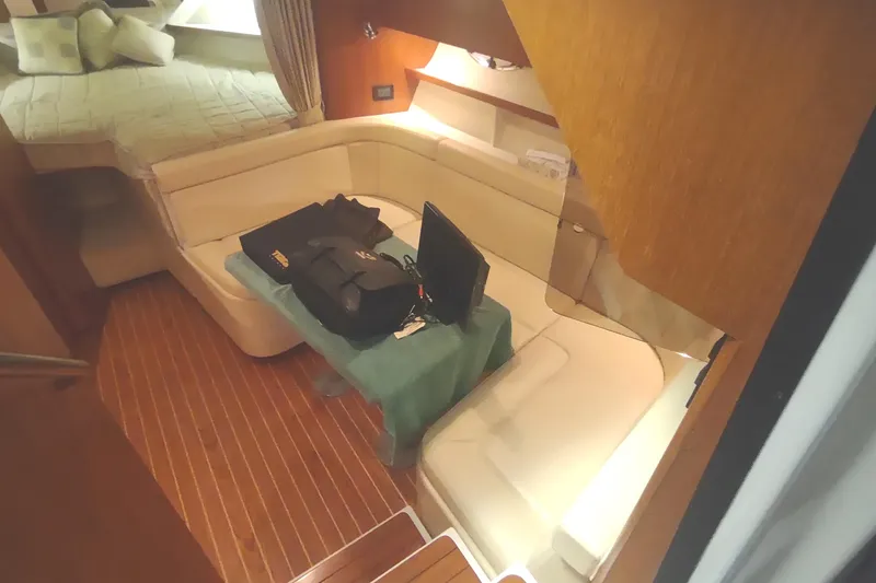 Slide: The Image of Interior of 2003 Tiara Yachts 3100 Open LE with seating and table setup. - 34
