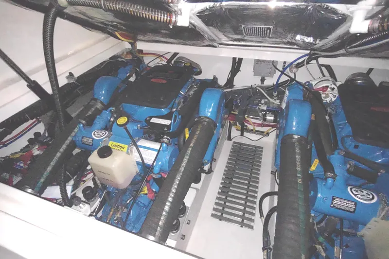 Slide: The Image of Engine compartment of 2003 Tiara Yachts 3100 Open LE, showcasing dual blue engines. - 36