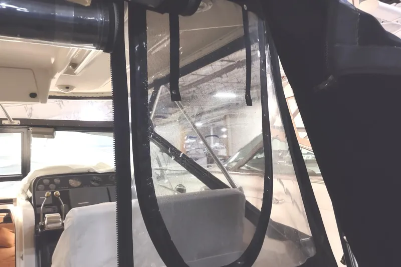 Slide: The Image of Interior view of a 2003 Tiara Yachts 3100 Open LE, showcasing helm and seating area. - 7