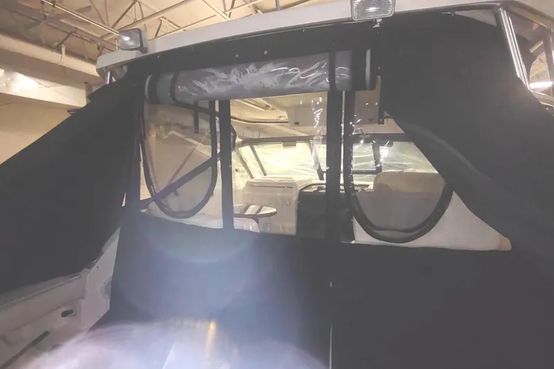 Slide: The Image of 2003 Tiara Yachts 3100 Open LE interior with protective covers and visible cockpit area. - 8