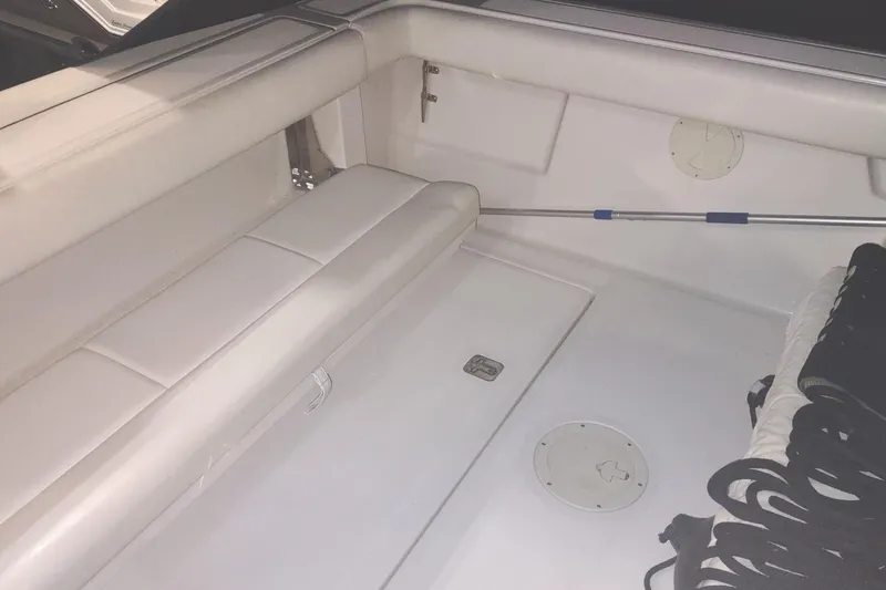 Slide: The Image of 2003 Tiara Yachts 3100 Open LE interior with white seating and storage compartments. - 9