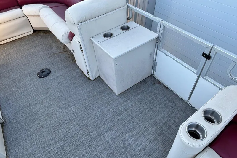 Slide: The Image of Interior of a 2000 JC Manufacture 24 Dolphin boat with seating and cup holders. - 4