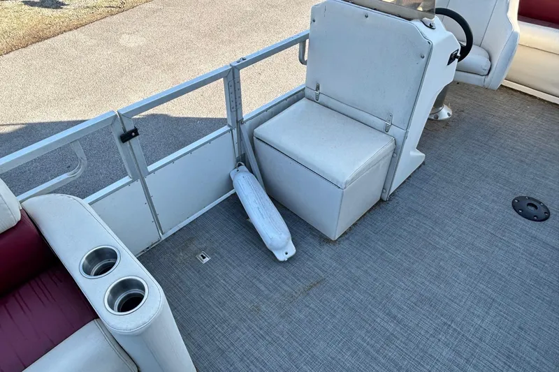 Slide: The Image of Interior of a 2000 JC Manufacture 24 Dolphin boat with seating and cup holders. - 5