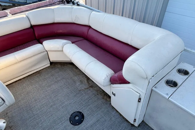 Slide: The Image of Interior seating of a 2000 JC Manufacture 24 Dolphin boat with red and white upholstery. - 6