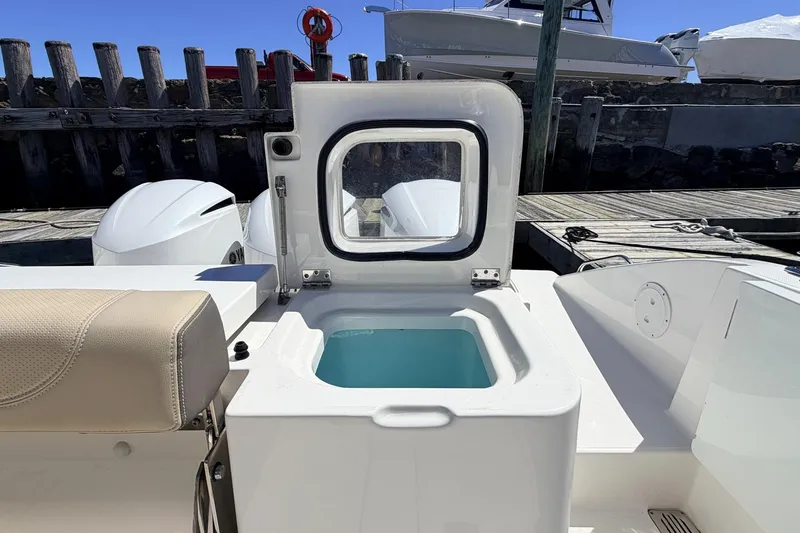 Slide: The Image of 2020 Pursuit OS 355 Offshore boat with open hatch and seating, docked at marina. - 11