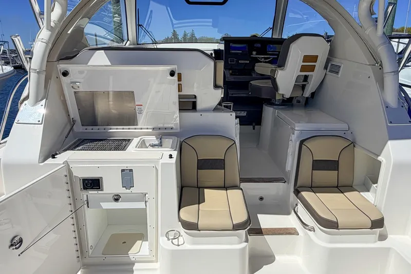 Slide: The Image of 2020 Pursuit OS 355 Offshore boat interior with seating and control panel. - 13