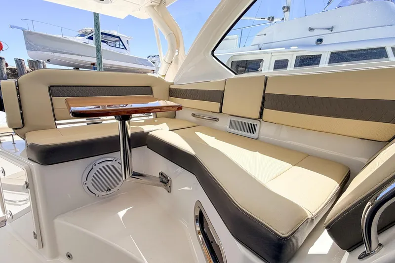 Slide: The Image of Luxurious interior of 2020 Pursuit OS 355 Offshore boat with cushioned seating and table. - 20