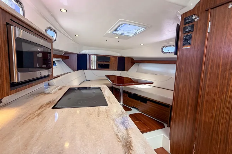 Slide: The Image of Luxurious interior of 2020 Pursuit OS 355 Offshore boat with modern kitchen and seating area. - 22