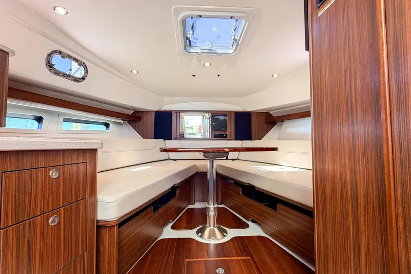 Slide: The Image of Luxurious interior of 2020 Pursuit OS 355 Offshore boat with wood finish and seating area. - 23