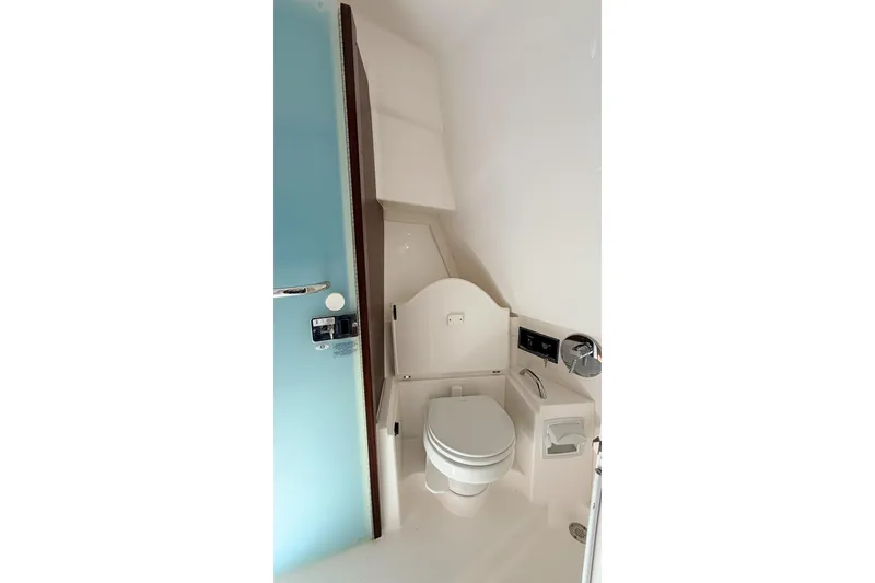 Slide: The Image of 2020 Pursuit OS 355 Offshore boat bathroom with modern fixtures and compact design. - 27