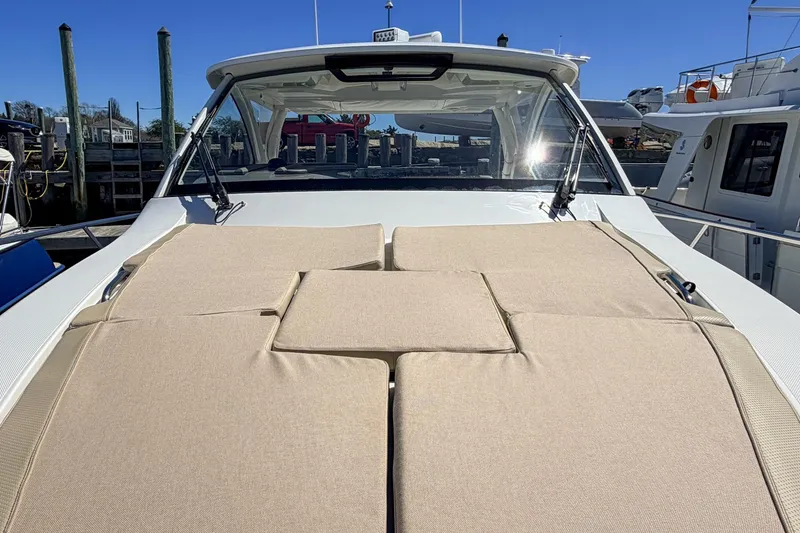 Slide: The Image of 2020 Pursuit OS 355 Offshore boat with beige sun pads on deck. - 3